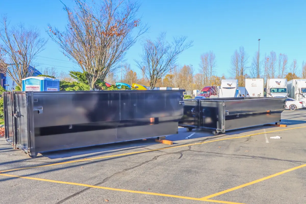 Professional dumpster rental service with roll-off container on residential driveway in Stroudsburg